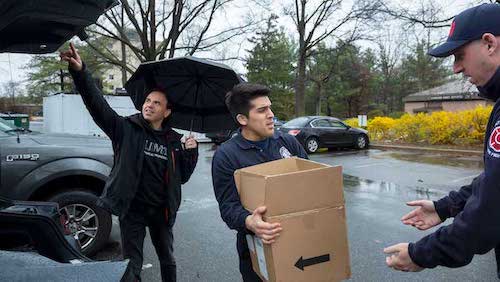 Firefighters unload boxes of hand sanitizer (Photos by Stephanie S. Cordle)
