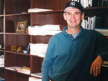 Professor Ray Paternoster in his office beside bookcases