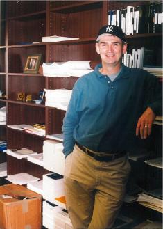 Professor Ray Paternoster in his office beside bookcases